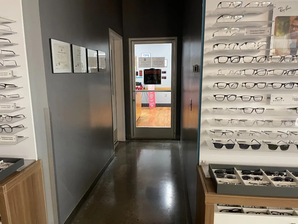 Hallway at Clear Sight Hawaii lined with designer eyeglass frames — Ray-Ban, Oakley, and more